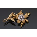 18ct gold and diamond floral spray brooch by Cropp & Farr, a polished and textured leaf design
