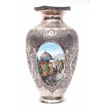 An interesting Russian white metal vase, heavily chased with bird and foliate designs and also