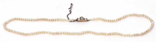 Antique seed pearl necklace, a single row of small pearls to a box engraved clasp set with three