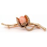 Antique coral and diamond brooch centring a coral bud in a diamond set cup within a diamond
