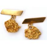 A pair of high grade yellow metal nugget cuff links, chain connectors t oplain polished bar fitting,