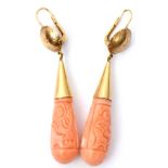 Pair of vintage carved coral torpedo drop earrings, each carved one side with a figure, the other