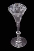 Mid-18th century light baluster wine glass with trumpet bowl engraved with fruiting vine above a