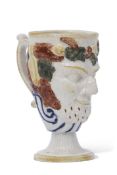 Early 19th century Staffordshire Rodney or Bacchus cup decorated in polychrome, the interior with