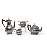 Late Victorian four-piece tea and coffee service in rococo style with heavily chased and embossed