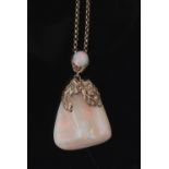 White crystal opal pendant of irregular triangular form, 40 x 35mm, decorated with a yellow metal