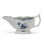 Small Lowestoft porcelain sauce boat, the reeded body with two panels decorated in underglaze blue