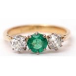 Emerald and diamond three-stone ring, the centre a circular shaped faceted emerald between two old