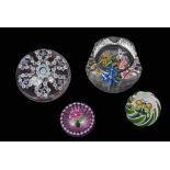 Group of paperweights including three Perthshire weights with multi-coloured designs and a