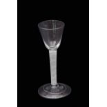 Mid-18th century wine glass, the rounded funnel bowl above a multi-spiral opaque twist stem and