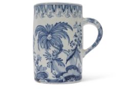 Large 18th/19th century Delft ware tankard, with an armorial design to centre bordered by floral