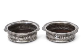 Pair of George III coasters of circular shape with applied shell and gadrooned rims, wrythen fluting