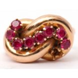 Stylised ruby set dress ring, an entwined plain polished tubular design set with eight small