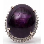 Large amethyst and diamond dress ring, the large oval shaped cabochon 24mm x 24mm, four claw set and