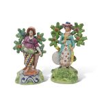 Two Walton type Staffordshire figures, circa 1840, standing against bocage, one of a fish seller,