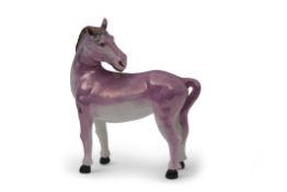 Unusual lustre ware model of a horse, its head looking backwards, covered in a purple lustre ware