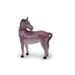 Unusual lustre ware model of a horse, its head looking backwards, covered in a purple lustre ware