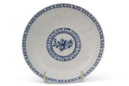 18th century Lowestoft porcelain saucer, the reeded body with a floral sprig to centre, bordered