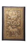 Burmese gold thread decorated wall hanging, the centre depicting a mythological scene of figure,