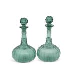 Two 19th century cut glass decanters stained green with star cut bases, 28cm high (2)