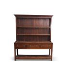 Late Georgian mahogany oak dresser having a two-shelf panelled back, the base section of three