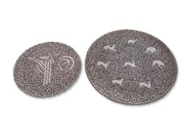 Two Middle Eastern chargers, probably Persian, with silver metal designs on copper, the larger