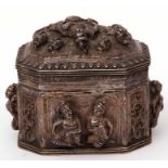 19th century Indian white metal lidded box of sarcophagus form, the sides and lid heavily embossed