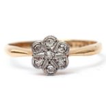 Precious metal diamond cluster ring featuring seven single cut diamonds in a flower head design,