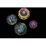 Group of four paperweights including a Baccarat primrose weight with a blue flower with white