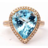 Blue topaz and diamond ring, a pear cut blue topaz, approx 7.48ct set within a diamond surround,
