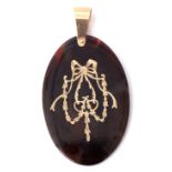 Victorian tortoiseshell pique pendant, oval shaped and inlaid with a golden bow and garland