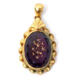 Victorian oval purple glass pendant, the faceted centre engraved and set with six small milk glass