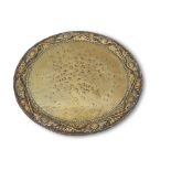 Early 20th century Arts & Crafts circular brass tray, having foliate and scrolled edge, spot
