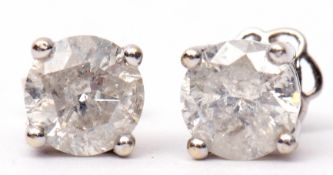 Pair of diamond stud earrings, round brilliant cut, four claw set, mounted in a double gallery,