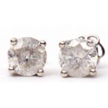 Pair of diamond stud earrings, round brilliant cut, four claw set, mounted in a double gallery,