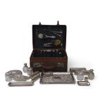 Edwardian leather travelling case with a majority of the original fittings including five silver