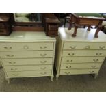 PAIR OF CREAM AND GILDED FIVE FULL WIDTH DRAWER CHESTS ON SHAPED FEET