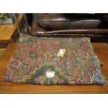 GOOD QUALITY BOKHARA TYPE CARPET WITH RED GROUND AND MULTI-COLOURED GEOMETRIC DESIGN