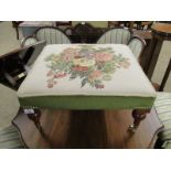 GOOD QUALITY SQUARE SQUAT FOOTSTOOL WITH FLORAL EMBROIDERED CENTRE RAISED ON TURNED BRASS CASTERS