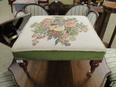 GOOD QUALITY SQUARE SQUAT FOOTSTOOL WITH FLORAL EMBROIDERED CENTRE RAISED ON TURNED BRASS CASTERS