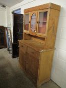 WAX PINE DRESSER WITH TWO GLAZED DOORS AND ETCHED PANEL OVER TWO DRAWERS WITH TWO PANELLED