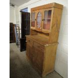 WAX PINE DRESSER WITH TWO GLAZED DOORS AND ETCHED PANEL OVER TWO DRAWERS WITH TWO PANELLED