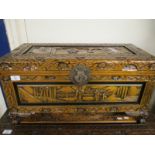 SMALL CAMPHOR WOOD CARVED ORIENTAL TRUNK WITH DECORATIVE LOCK RAISED ON SQUAT FEET