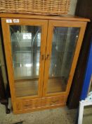 PINE EFFECT TWO GLAZED DOOR DISPLAY CABINETS WITH FULL WIDTH DRAWER TO BASE