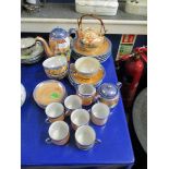 QUANTITY OF JAPANESE TEA WARES WITH ORANGE AND BLUE LUSTRE WITH DECORATIVE SCENES
