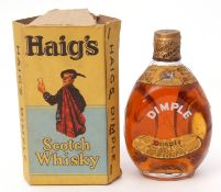 Dimple Haig Scotch Whisky, 70% proof, half bottle in a torn and worn cardboard carton