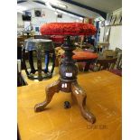 VICTORIAN CARVED OAK ADJUSTABLE PIANO STOOL WITH RED UPHOLSTERED TOP