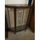 MID-20TH CENTURY WALNUT DEMI-LUNE DISPLAY CABINET, THE SINGLE GLAZED DOOR WITH PAINTED DETAIL RAISED
