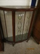 MID-20TH CENTURY WALNUT DEMI-LUNE DISPLAY CABINET, THE SINGLE GLAZED DOOR WITH PAINTED DETAIL RAISED