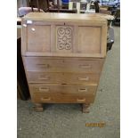 OAK FRAMED BUREAU WITH CARVED PANEL WITH DROP FRONT OVER FOUR FULL WIDTH DRAWERS RAISED ON TURNED